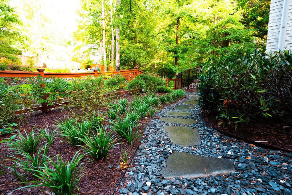 Graveled path stones and landscaped shrubs