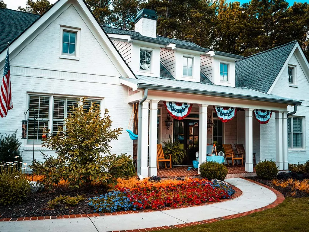 white house with red white and blue flower bed 1.jpg